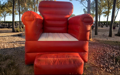 Red Inflatable Armchair With Footrest Outdoors — Fun Time Amusements in Gracemere, QLD
