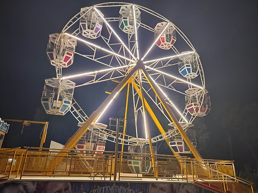 A Large Ferris Wheel is Lit Up at Night — Fun Time Amusements in Gracemere, QLD