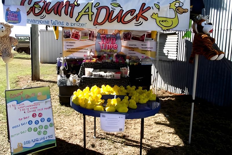 Duck Pond Game Booth; Yellow Rubber Ducks on a Blue Table; Prizes Offered — Fun Time Amusements in Gracemere, QLD