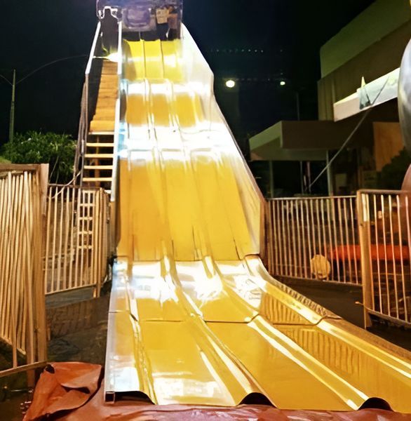 A Large Yellow Slide is Lit Up at Night — Fun Time Amusements in Bundaberg, QLD