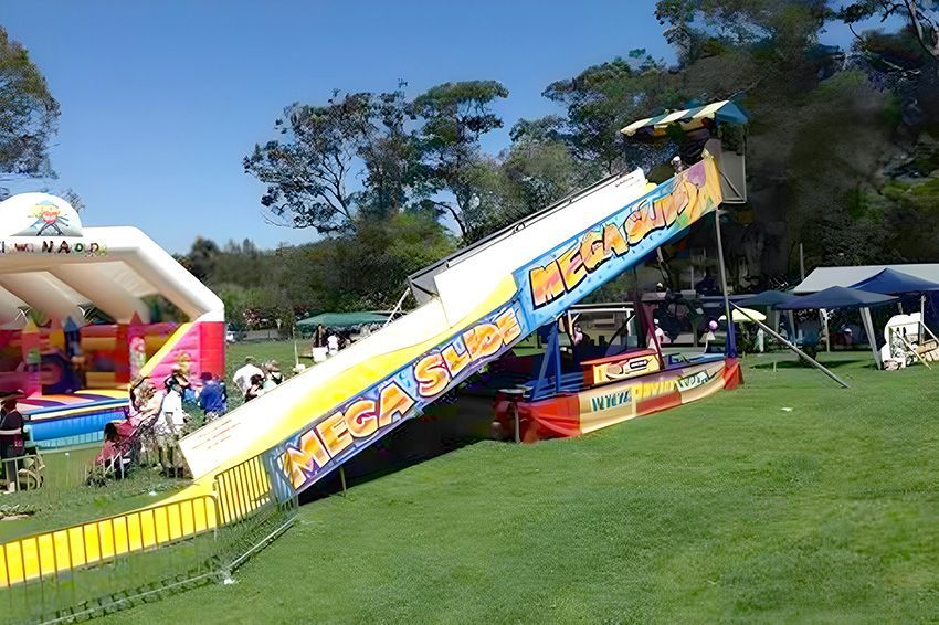 A Mega Slide is Sitting in the Middle of a Grassy Field — Fun Time Amusements in Gracemere, QLD