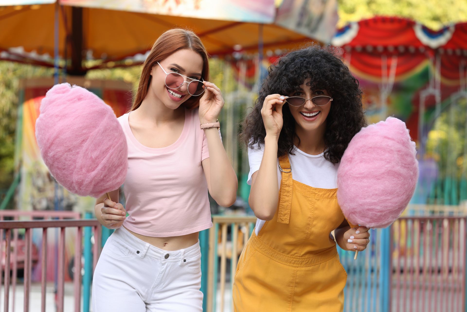 A Little Girl Wearing a Unicorn Headband is Eating Cotton Candy — Fun Time Amusements in Bundaberg, QLD
