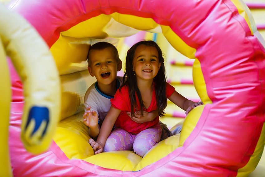 A Boy and a Girl Are Playing in a Bouncy House — Fun Time Amusements in Emerald, QLD