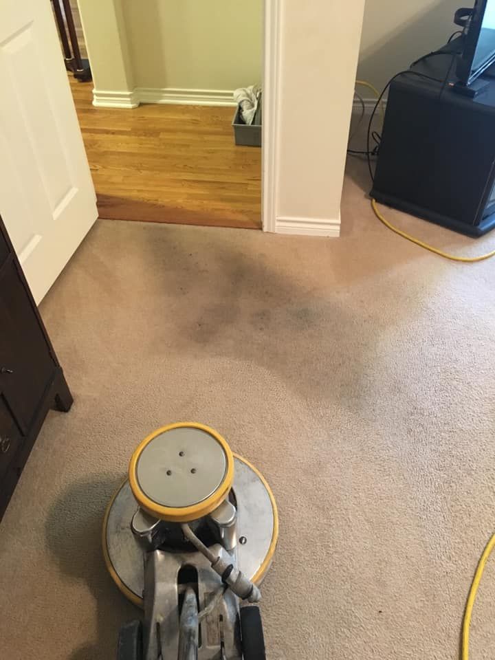 Carpet Master of Tulsa - A vacuum cleaner is cleaning a carpet in a living room.