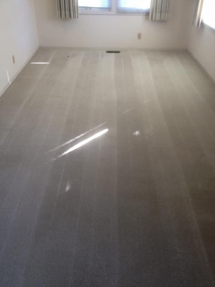 Carpet Master of Tulsa - A living room with a large carpeted floor and two windows.