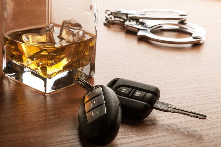 Car key beside whiskey glass