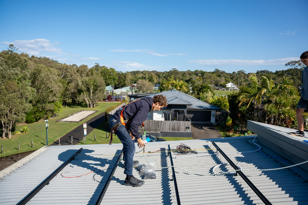 Electrician Installing Metal Panels for Solar Panels — Local Light Electrical in Ballina, NSW