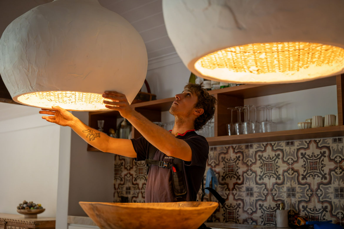 Worker Installing a Ceiling Attic Hatch in a White Room — Local Light Electrical in Suffolk Park, NSW