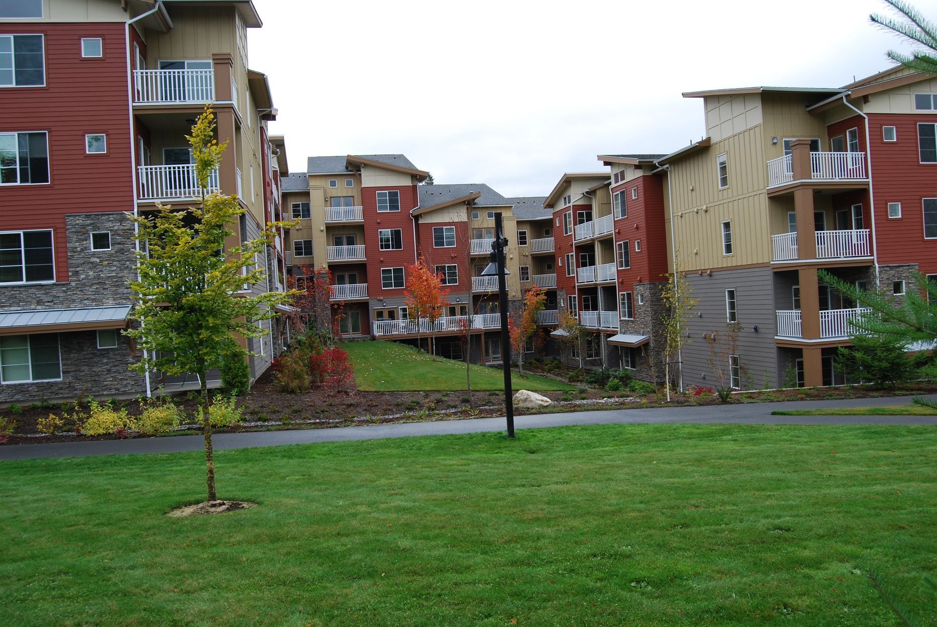 Apartment buildings around a green lawn on an overcast day
