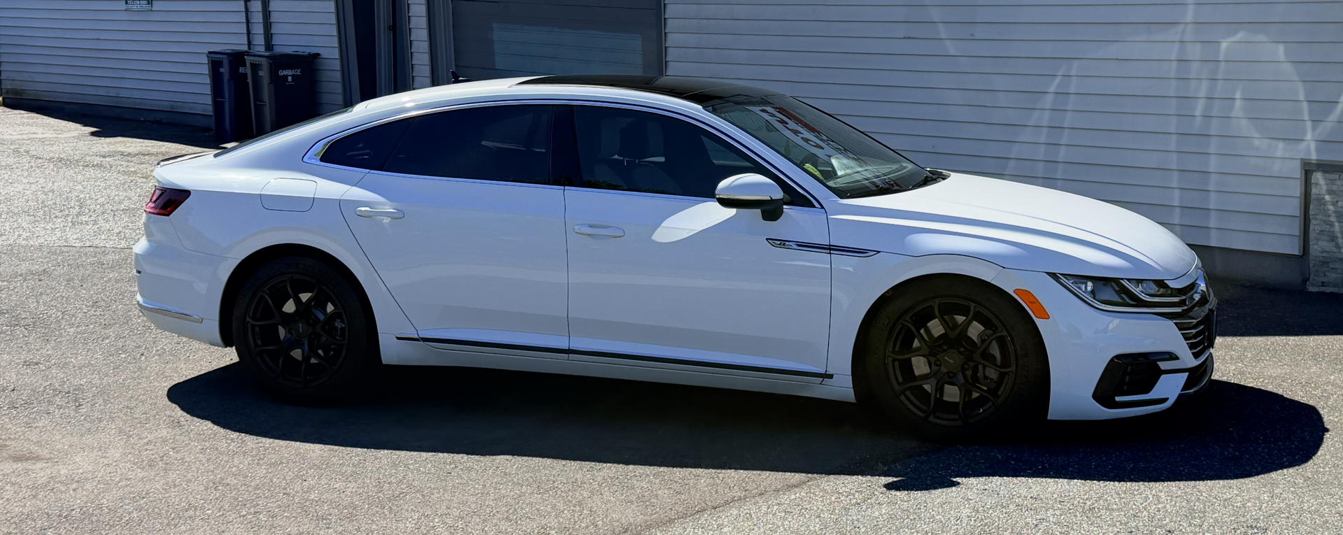 Gray hatchback car in side profile, isolated on a white background