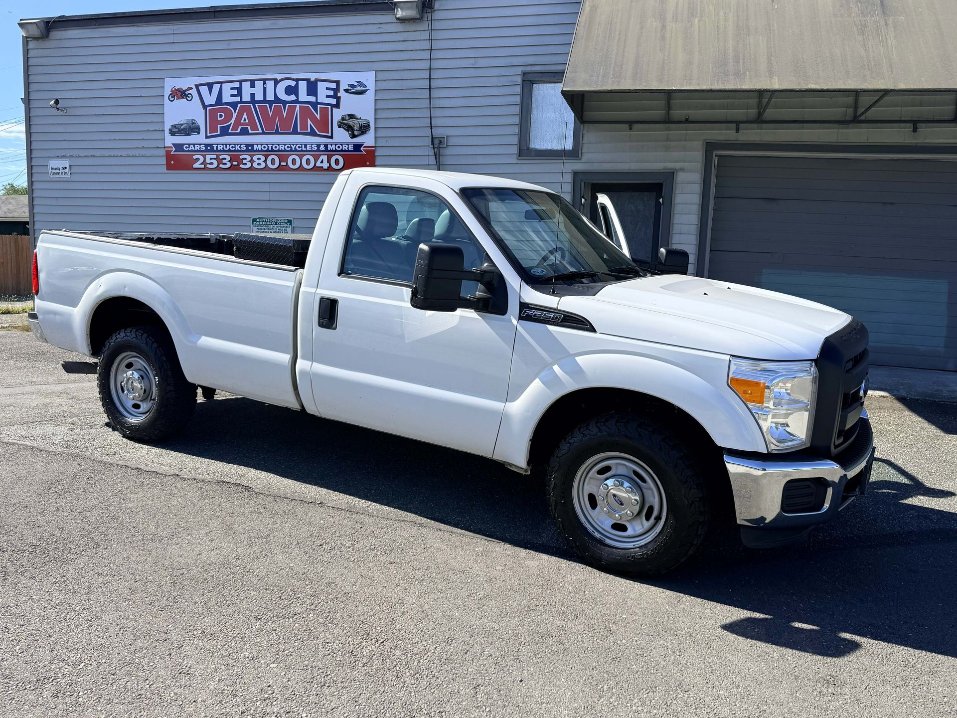 White Ford pickup truck parked in front of the Vehicle Pawn shop in Auburn WA