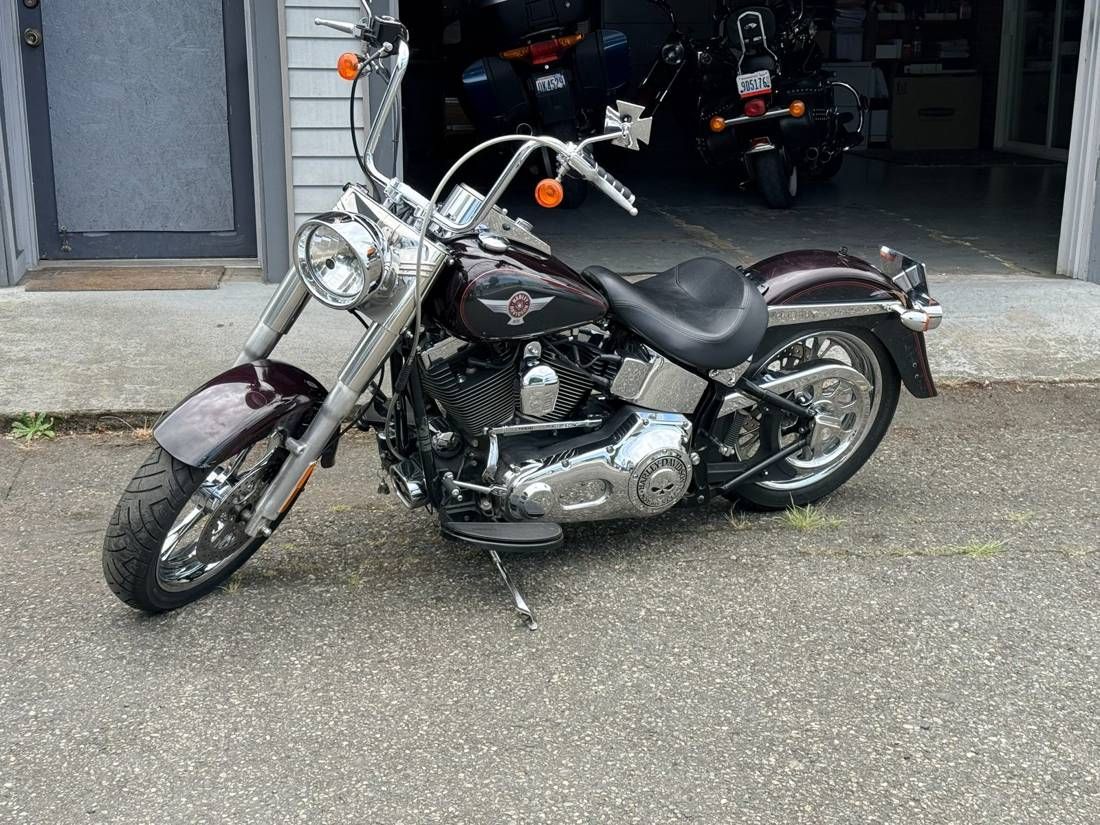 Maroon Harley-Davidson Softail motorcycle parked outside the Vehicle Pawn USA shop in Auburn WA
