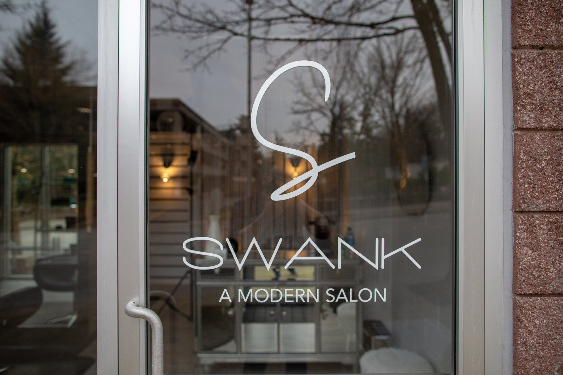 Swank salon door with white logo and