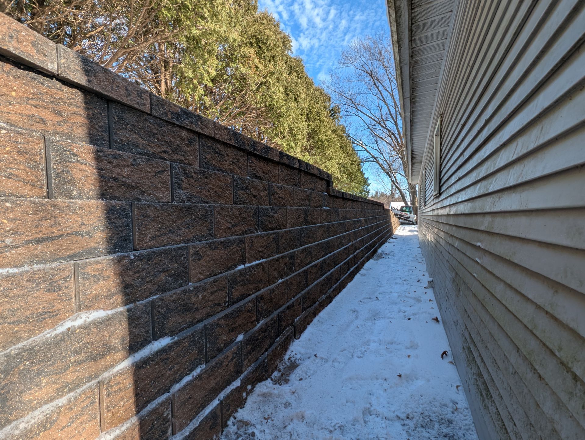 Brick retaining wall lining a stone walkway