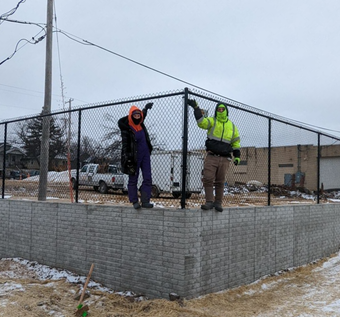 Two people by new fence Two people by new fence