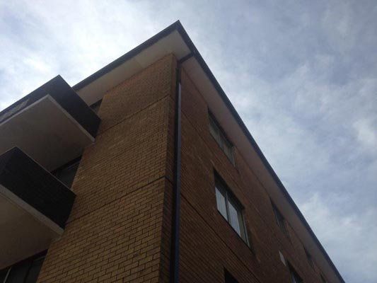 Looking up at the corner of a brick building