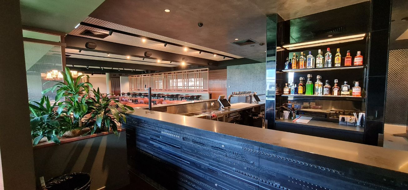 A Bar In A Restaurant With Lots Of Bottles On Shelves — Logic Joinery In Fountaindale, NSW