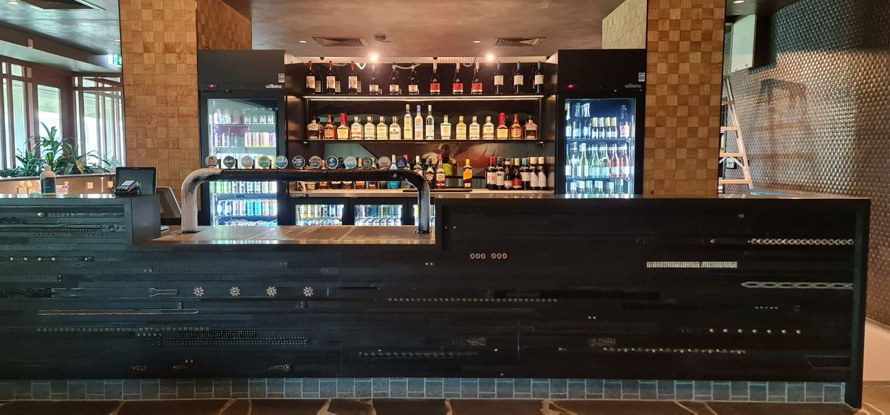 A Bar In A Restaurant With A Lot Of Bottles On The Shelf — Logic Joinery In Fountaindale, NSW