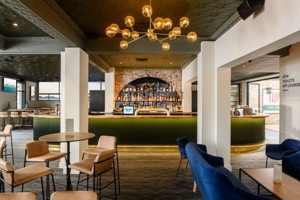 A Restaurant With Tables And Chairs And A Bar — Logic Joinery In Fountaindale, NSW