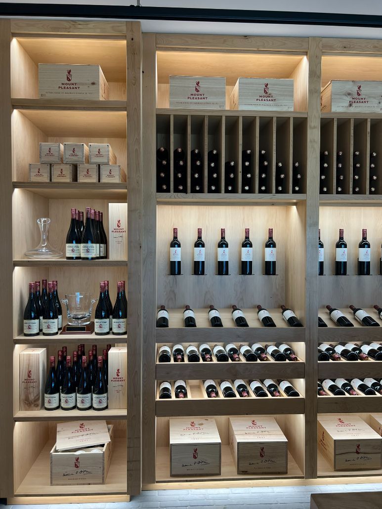 A Wall Of Shelves Filled With Bottles Of Wine — Logic Joinery In Fountaindale, NSW