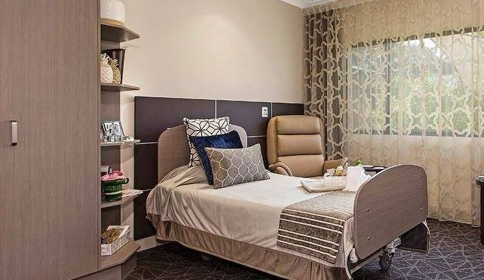 A Bedroom With A Bed And A Chair In It — Logic Joinery In Fountaindale, NSW