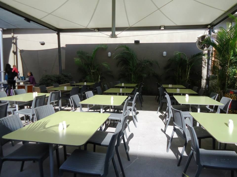 A Restaurant With Tables And Chairs Under An Awning — Logic Joinery In Fountaindale, NSW