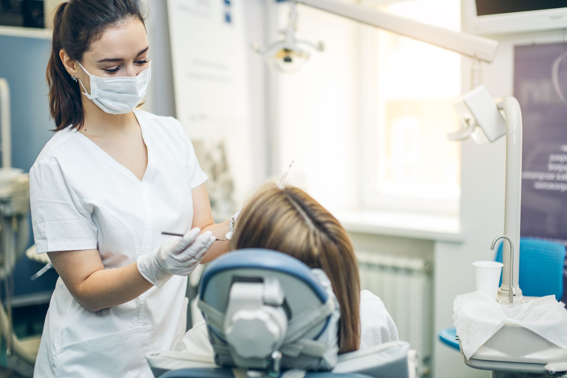 General Dentistry exam with a dentist preparing a patient for routine dental care.