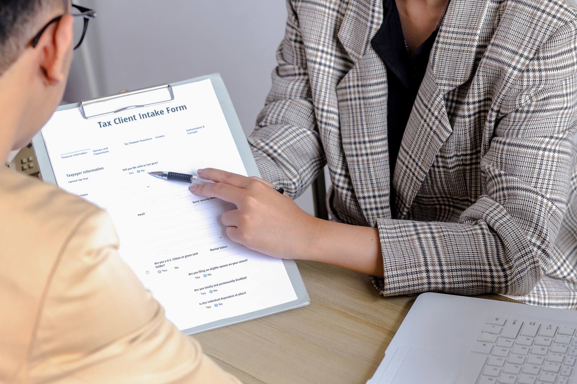 Professional tax advisory shown through financial paperwork review.