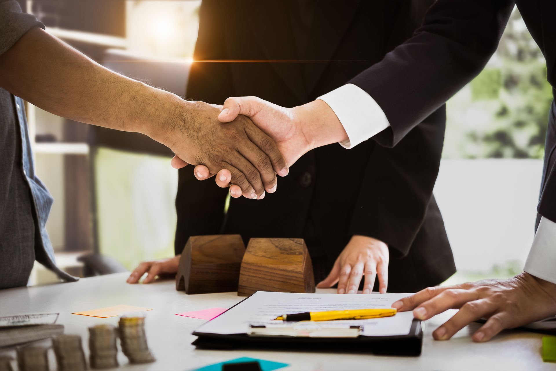 Client and agent shake hands, showcasing trust, representing certified public accountant services.