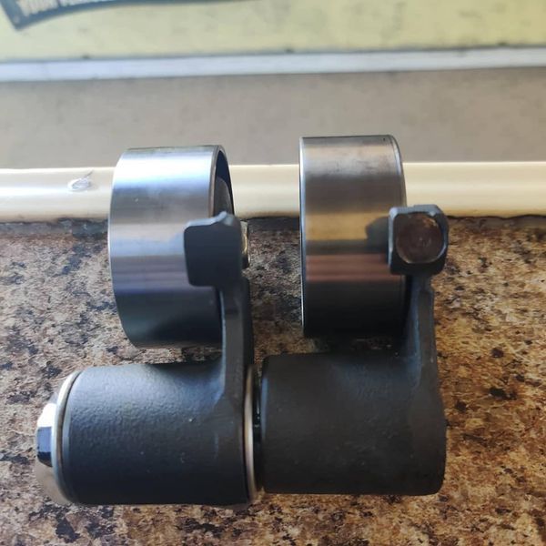 Two black-and-silver metal clamps or rollers resting on a granite countertop | Auto Pros