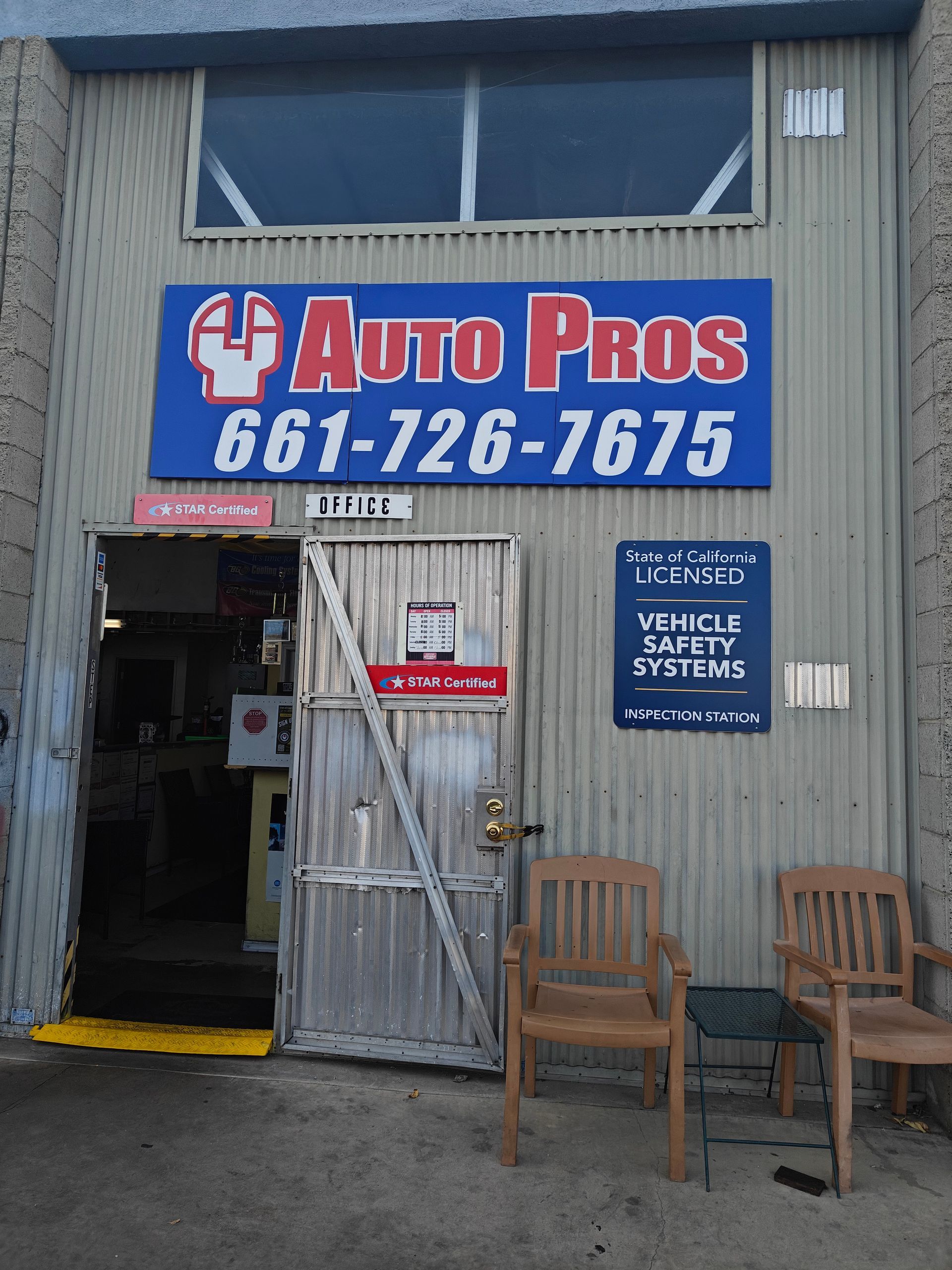 Auto Pros storefront with blue sign, open door, and chairs outside | Auto Pros