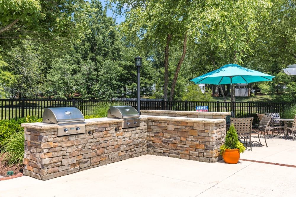 a grill and umbrella on the patio at Marquis on Cary Parkway in Morrisville, NC.