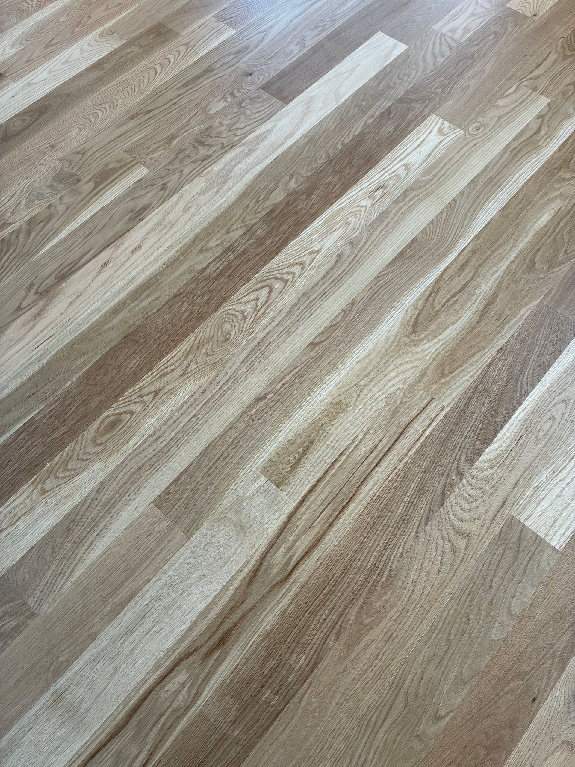 Light wood-patterned floor with diagonal planks in beige, gray, and brown tones