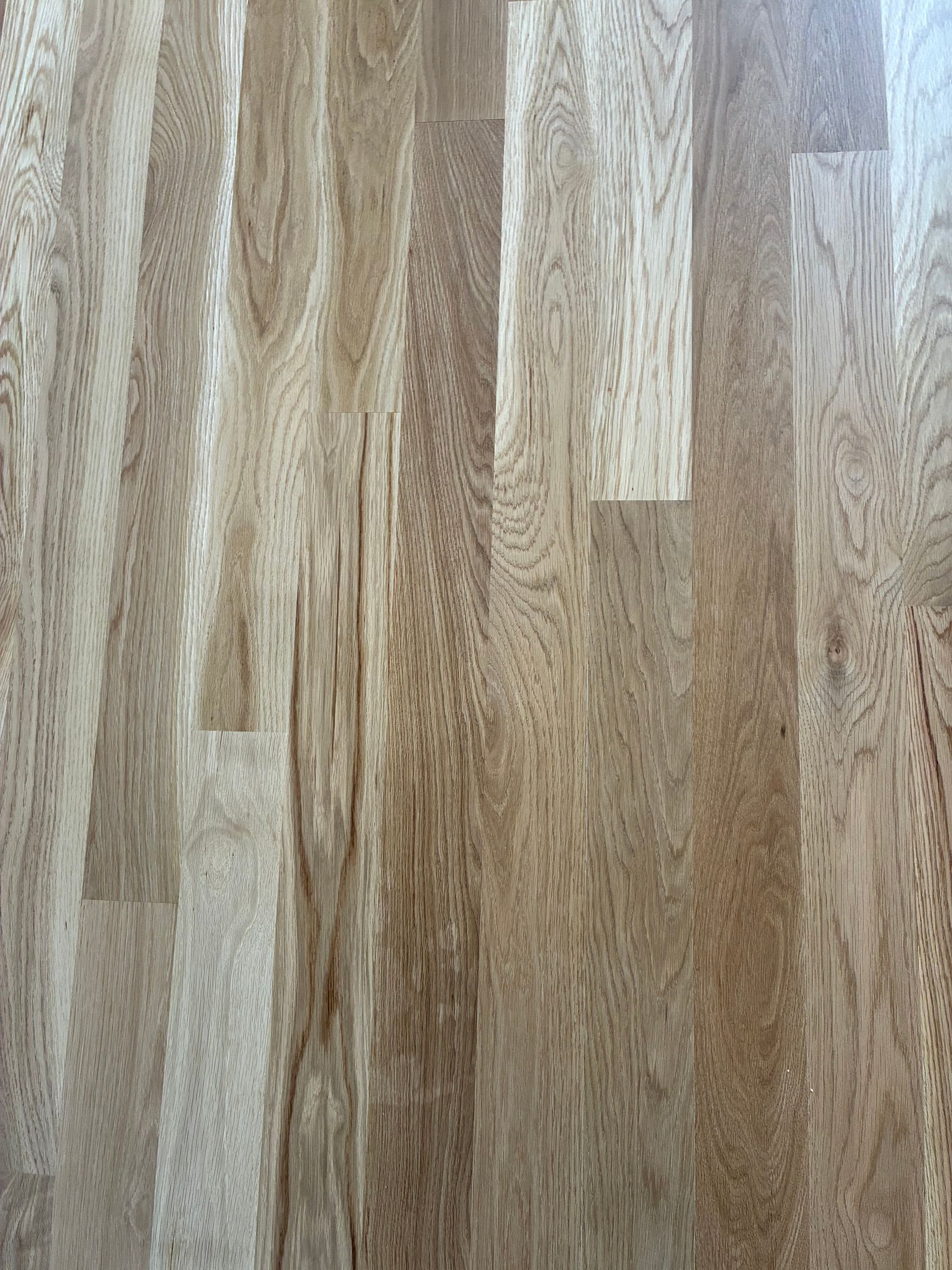 Wooden plank floor with light and medium brown grain pattern