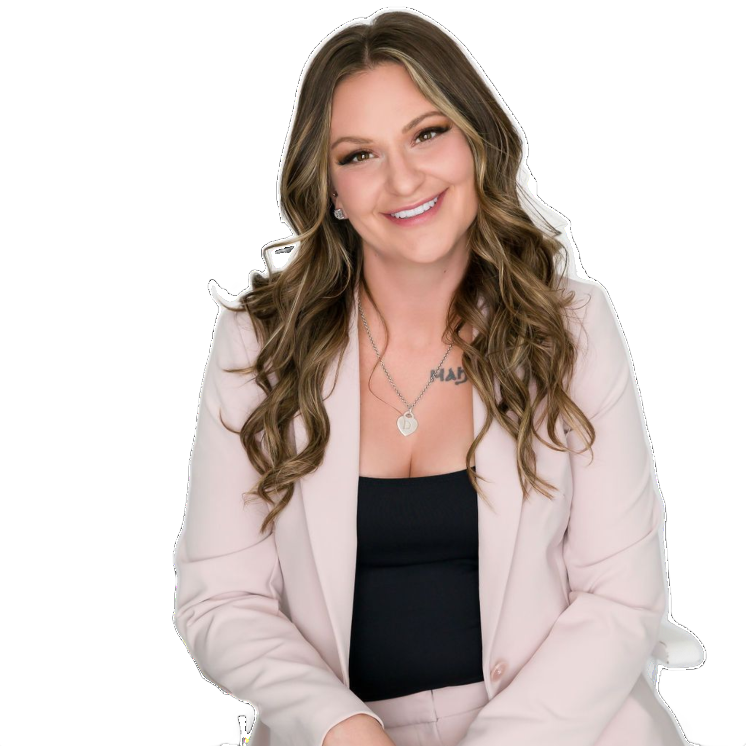 Smiling woman in a light pink blazer over a black top on a white background