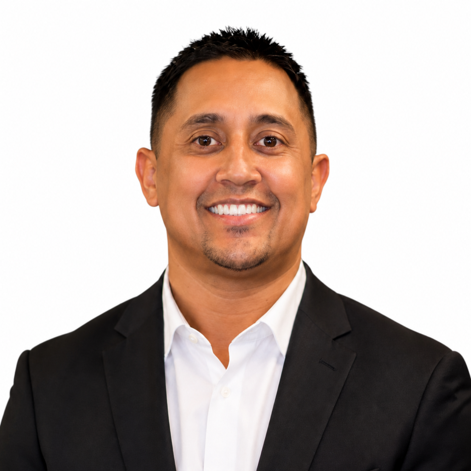 Smiling person in a black blazer and white shirt against a white background