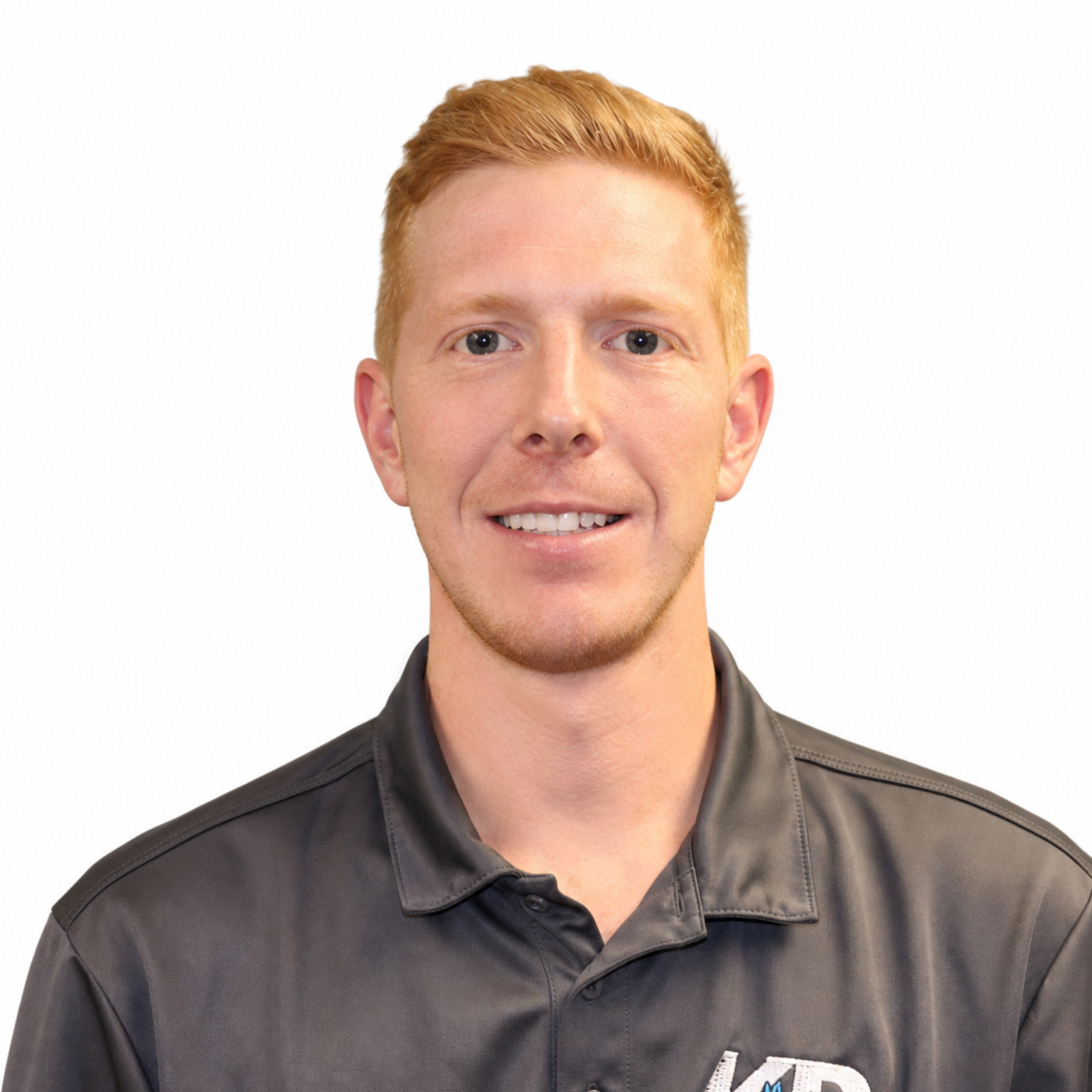 Portrait of a smiling person in a dark gray polo shirt against a white background