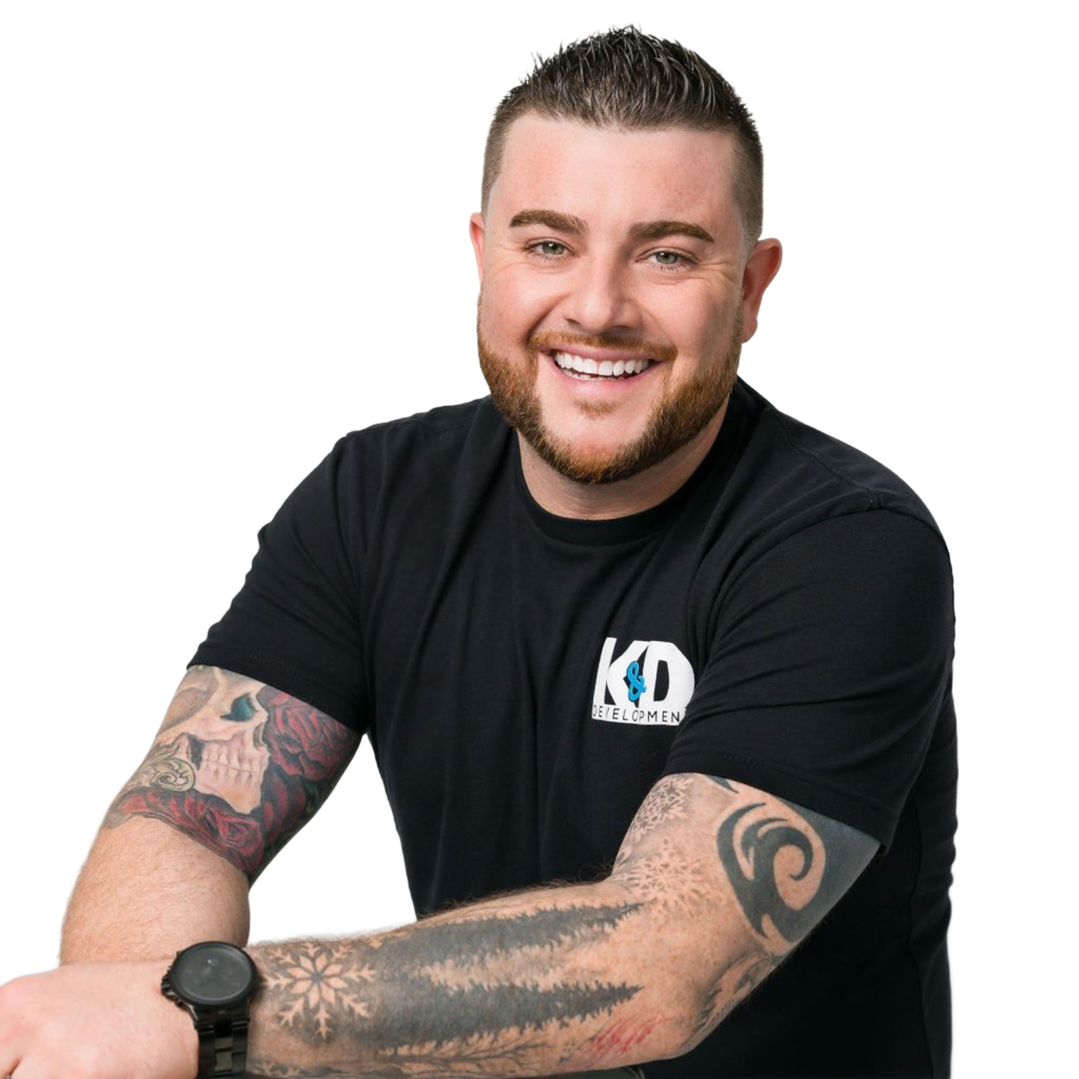 Smiling man with tattooed arms in a black T-shirt against a white background