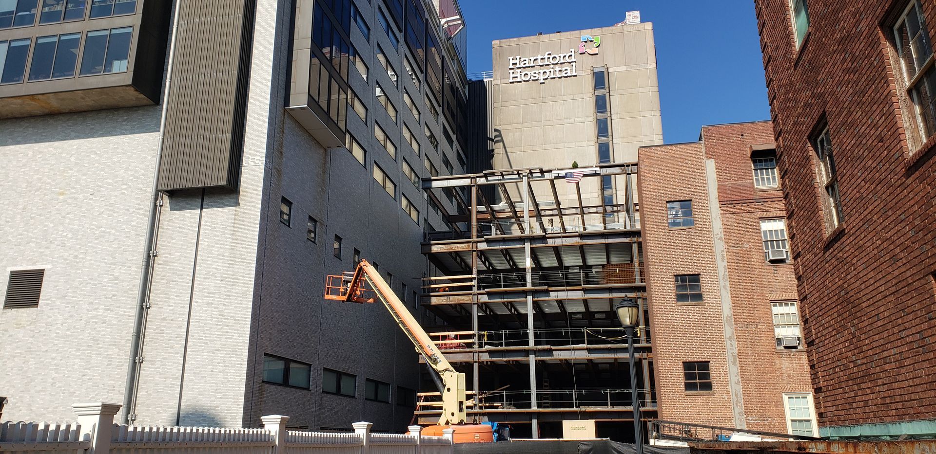 A large building under construction with a crane in front of it