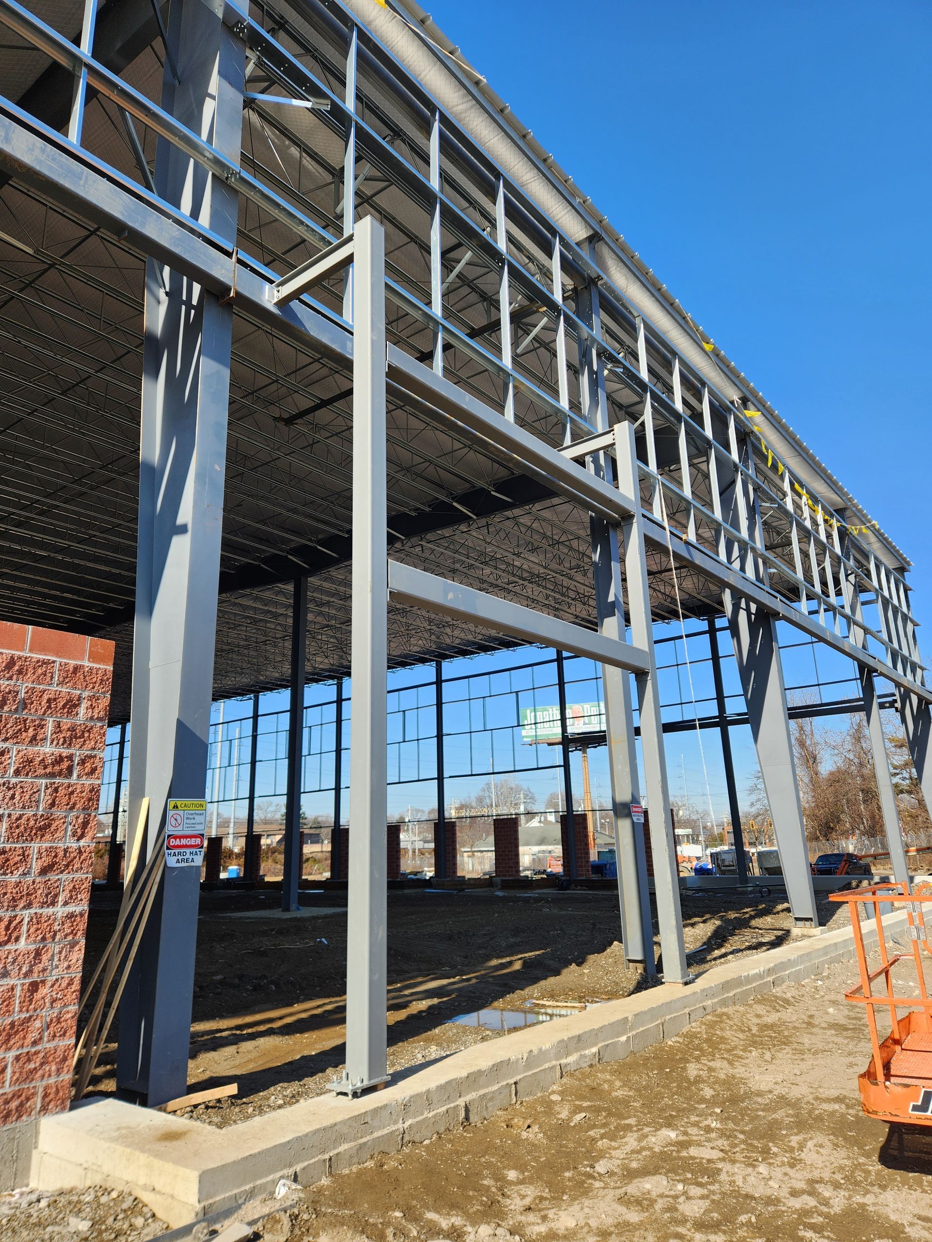 A large building under construction with a blue sky in the background.