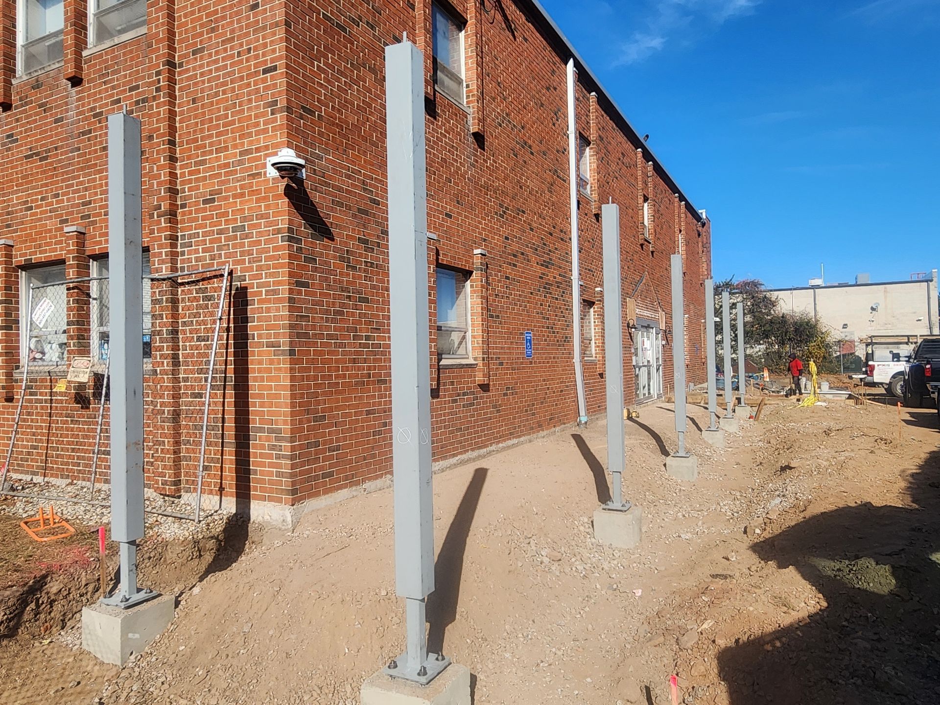 A brick building with a lot of metal poles in front of it