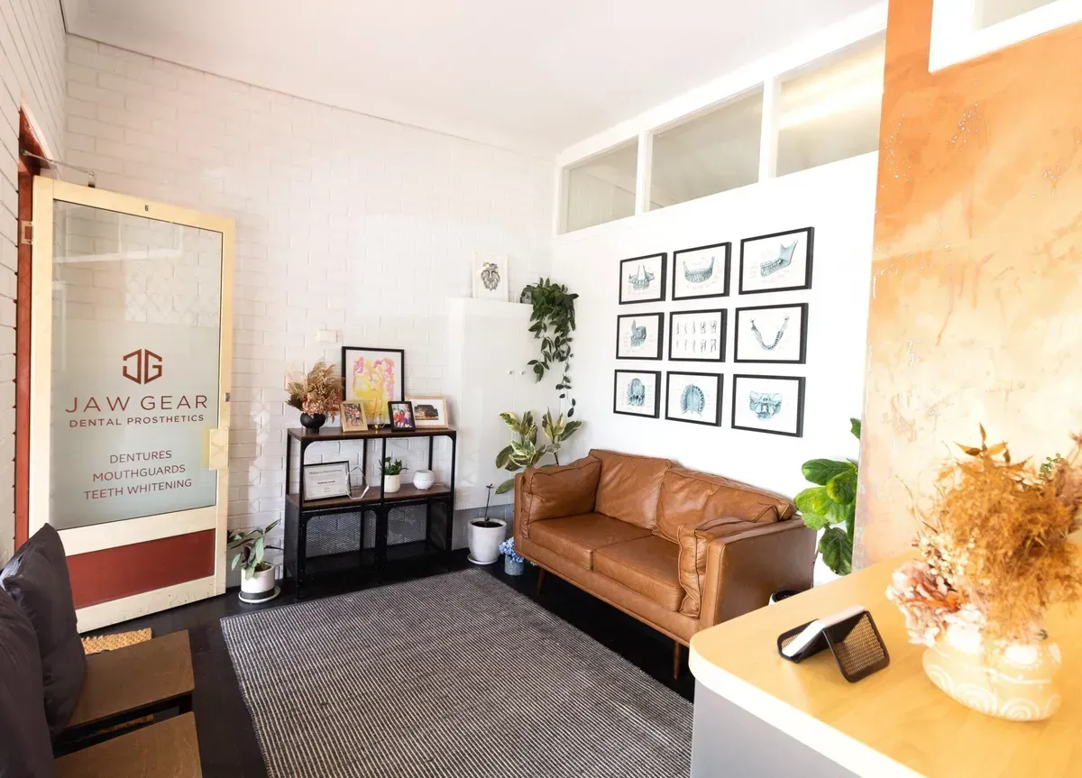 A Living Room With a Brown Couch and a Zebra Print Rug — Jaw Gear Dental Prosthetics in Bowral, NSW