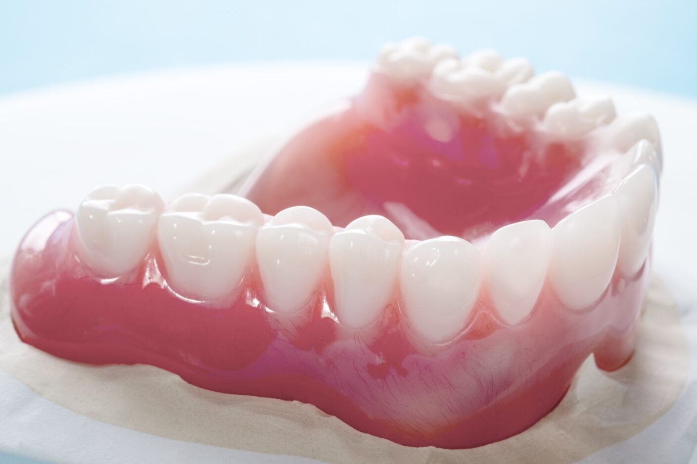 A Close Up of a Denture With White Teeth on a White Surface — Jaw Gear Dental Prosthetics in Bowral, NSW