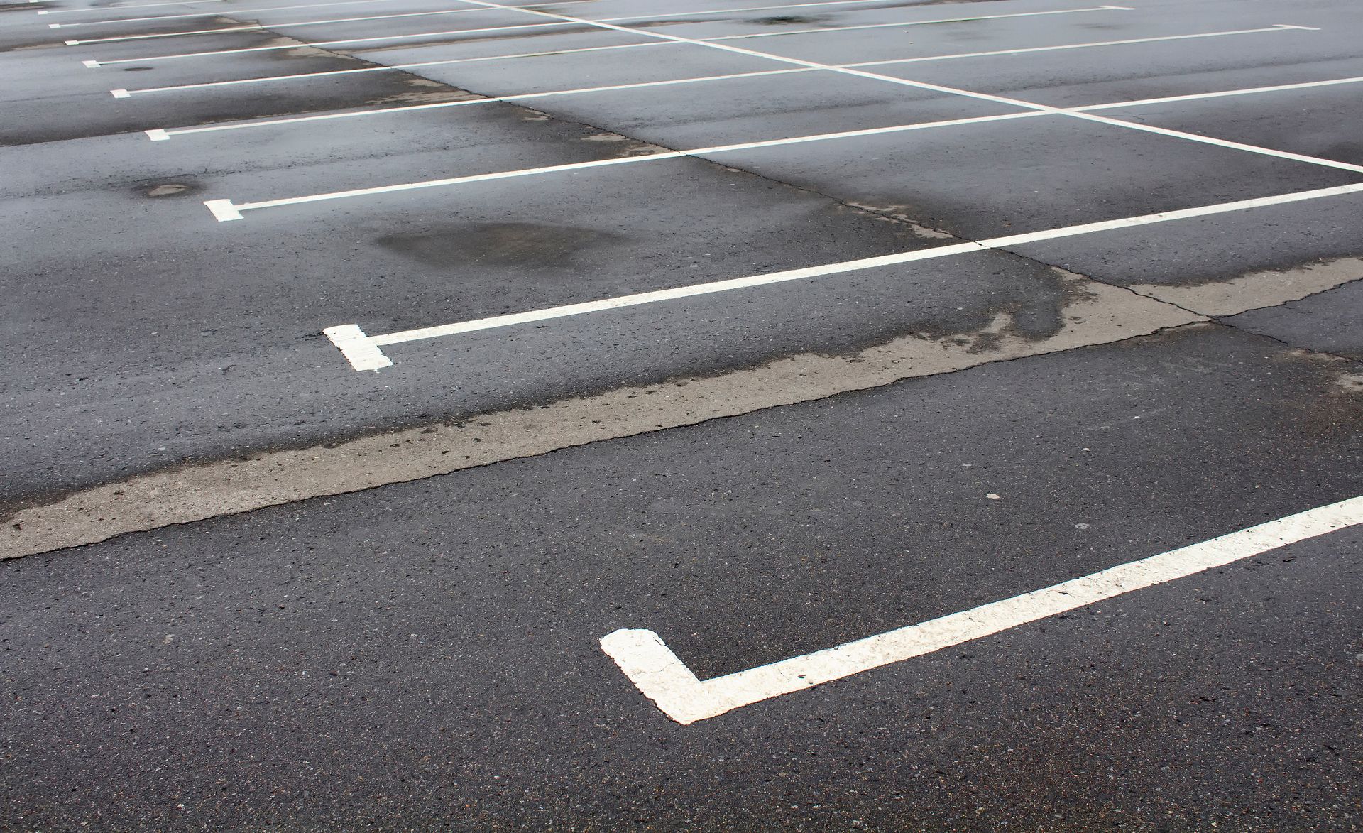 A person is writing on a clipboard in front of a house.