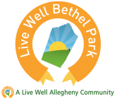 Live Well Bethel Park logo with orange circular ribbon, green hills, sun, and bridge