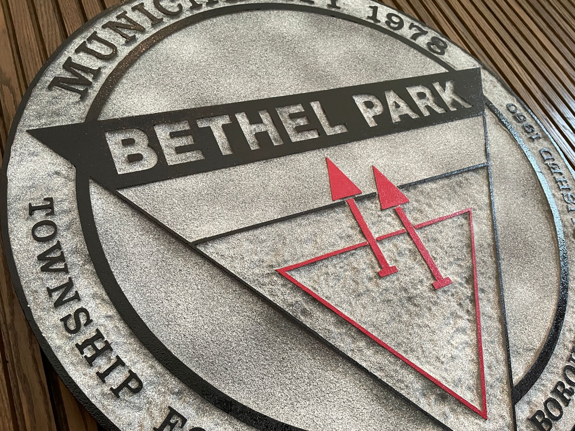 Bethel Park Township seal with black and silver text and red triangle emblem