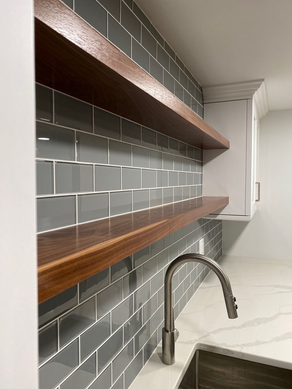 Bathroom with a tub, shower, and window. Neutral-toned tile and a clear glass shower door.