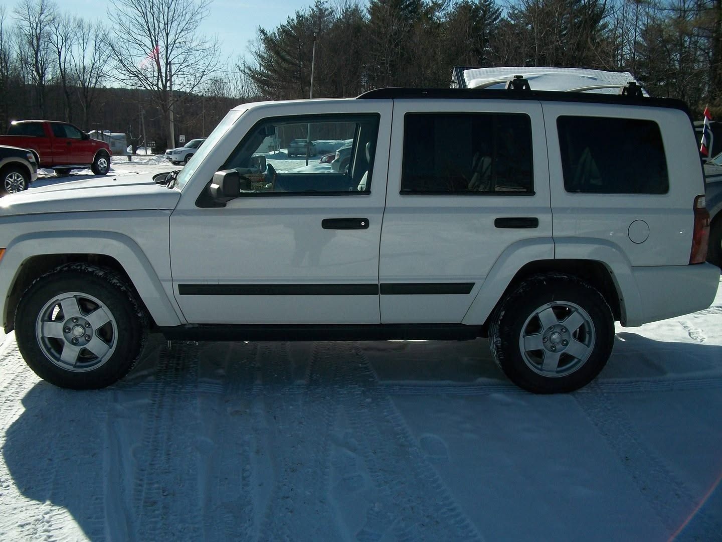 White SUV parked on snowy ground with trees in the background | Randy Keach Auto Repair