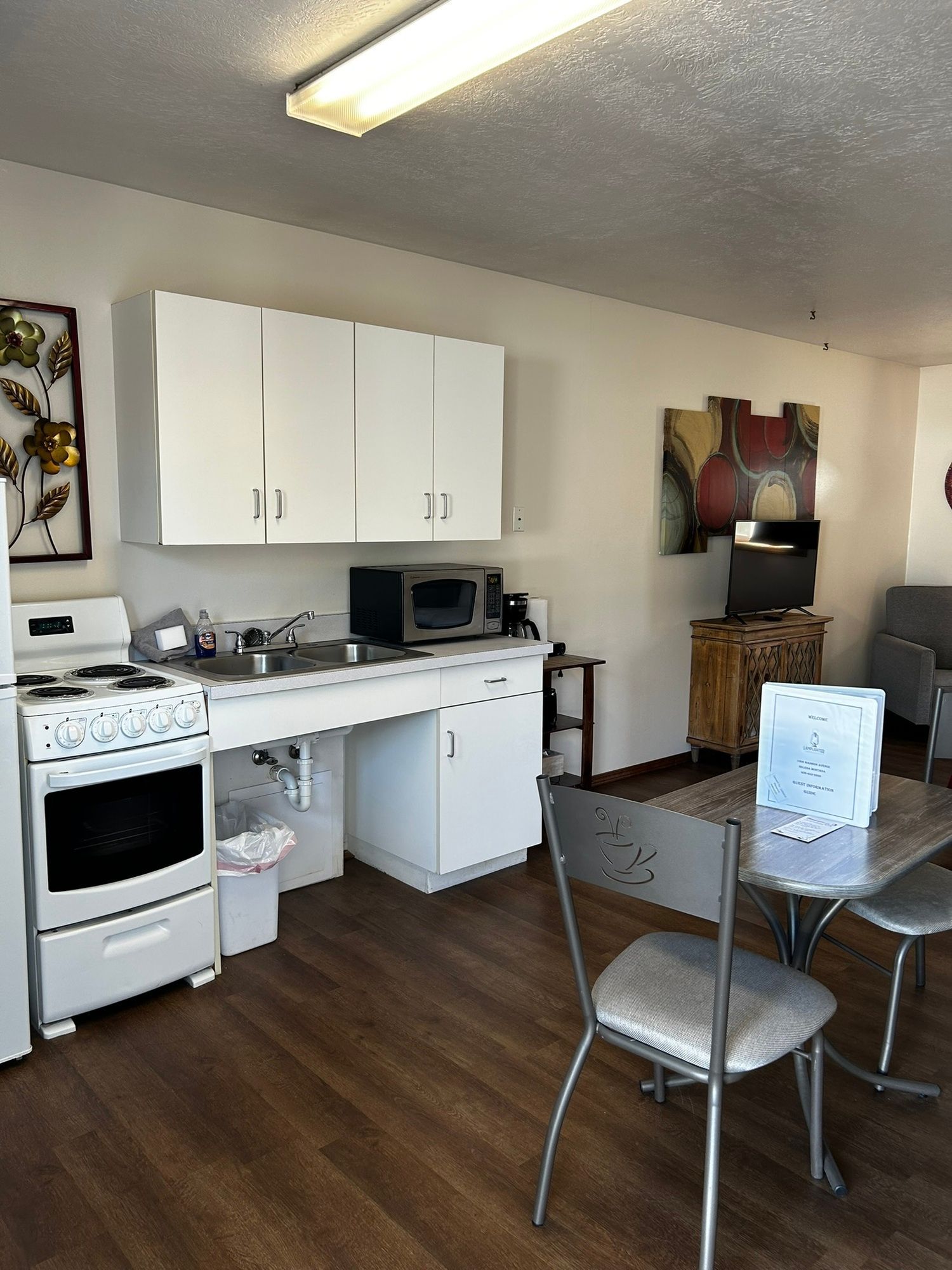 A kitchen with a table and chairs and a stove