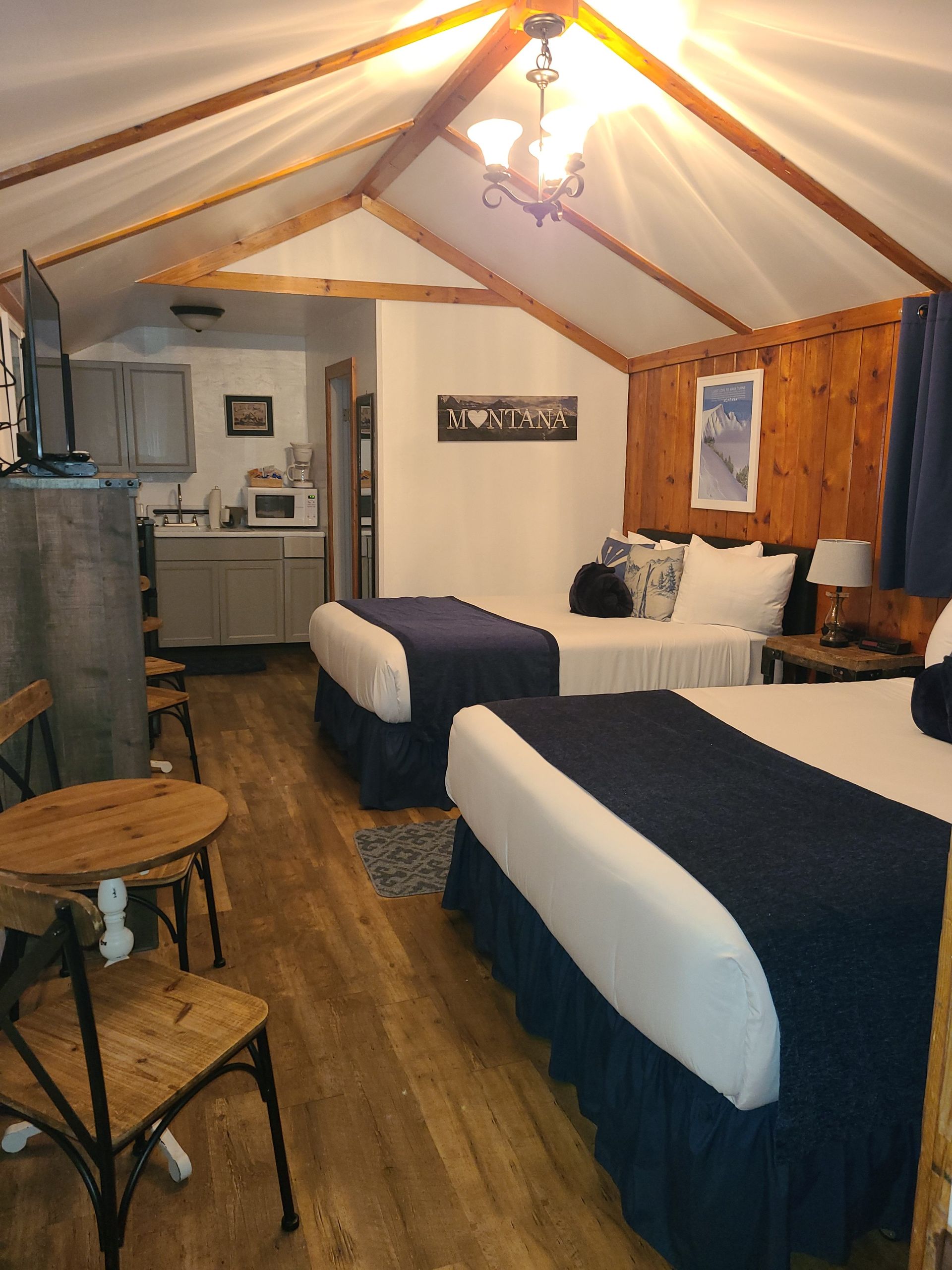 A hotel room with two beds and a chair